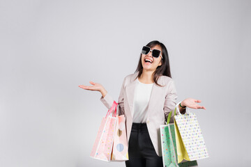 Woman with glasses confident shopper smiling holding online shopping bags colorful multicolor,...