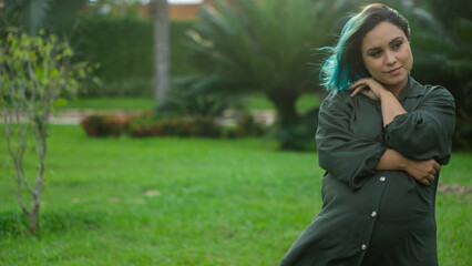 young pregnant woman outdoors in a square at sunset