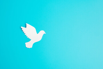 International Day of Peace. white paper Dove bird on blue background. Freedom, Hope and World Peace day 21 September concepts.