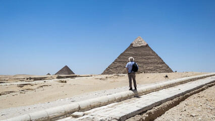 Architectural detail of the Giza pyramid complex located about 13 kilometers southwest of Cairo's city center. In the background, the Pyramid of Khafre or of Chephren - obrazy, fototapety, plakaty