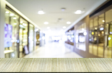 Close up. wooden table perspective, blurry hallway in shopping mall