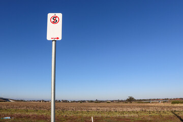 no standing sign on road against fields