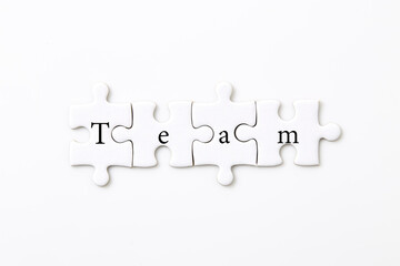 text team on puzzle pieces on a white