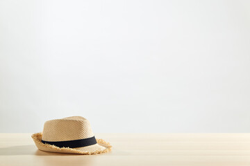Straw hats are placed on a wooden table