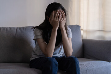 Mental health, depressed sad asian young woman, girl sitting on sofa, couch, expression to face...