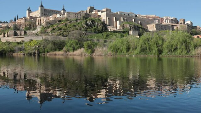 Picturesque landscape with a view of the Alcantara Bridge, spanning the Tagus River, and the ancient Alcazar de Toledo 