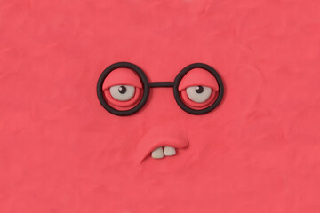 Nerd monster with glasses, fabulous creature made by hand from pink plasticine. Comic facial...