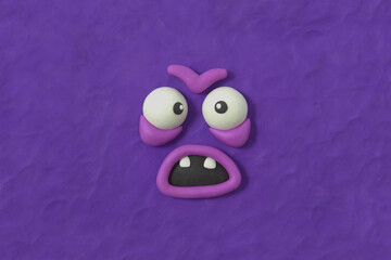 Ugly monster with furious expression, fabulous creature made by hand from purple plasticine. Scary...