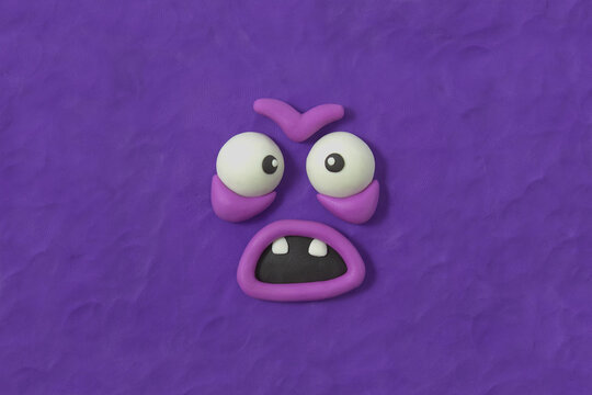 Ugly monster with furious expression, fabulous creature made by hand from purple plasticine. Scary face of alien monster. 3d artwork