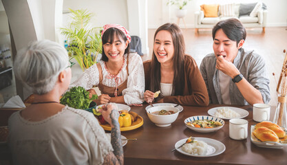 Asian family eating together mother and daughter and son.