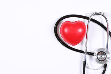 Stethoscope with red heart on orange background, heart examination, medical equipment the doctor...