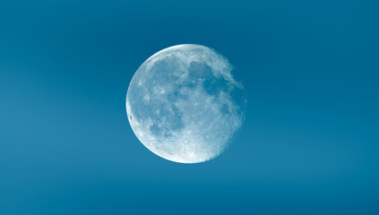 Full white Moon with blue sky 
