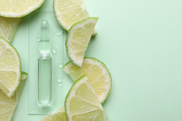 Pharmaceutical ampoule with medication and lime slices on turquoise background, flat lay. Space for...