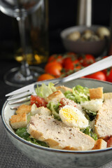 Delicious Caesar salad in bowl, closeup view