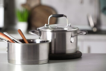Cookware and kitchen utensils on grey table