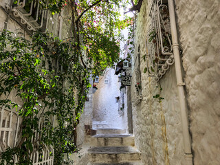 Narrow street in old town of Marmaris, Turkey . Beautiful scenic old ancient white houses with...