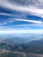 A beautiful view from the airplane window to the skies, mountains and plains