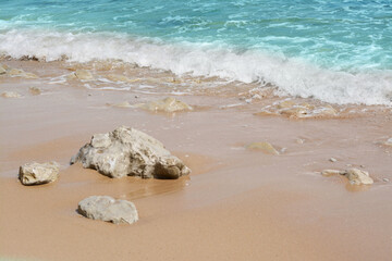 Beautiful view of sandy beach with rocks and sea. Summer vacation