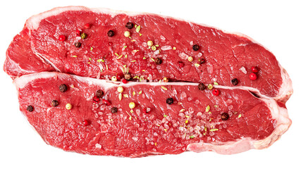 Fresh beef steak isolated on white background, top view. Raw meat fillet with spices and herbs.