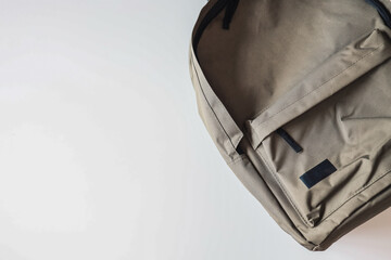 Men's khaki backpack on a white background, space for text