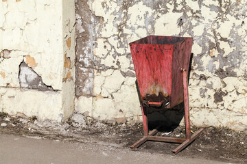 Rusty red trash can