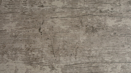 Grey wooden background of weathered distressed rustic wood with faded white paint showing woodgrain texture