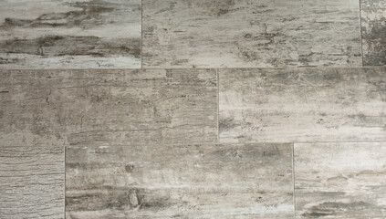 Grey wooden background of weathered distressed rustic wood with faded white paint showing woodgrain texture