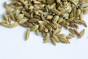 A top down image of a pile of whole fennel seeds his popular spice is used in many cuisines from European cuisine to Indian Cuisine, isolated on a white background
