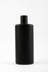 Black clean shampoo bottle isolated on white background