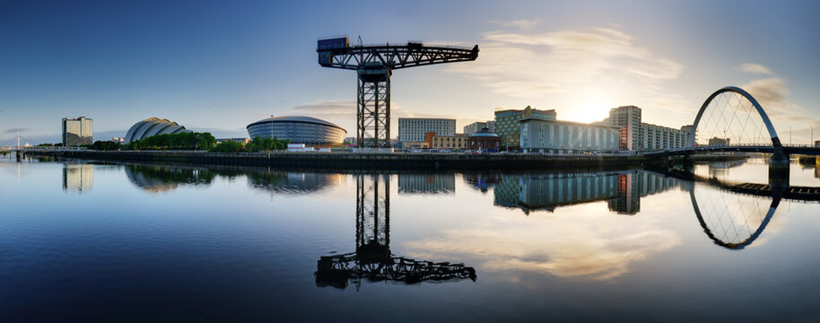 Glasgow Cityscape at sunrise, skyline panorama with reflecion in river with sun, Scotland - UK