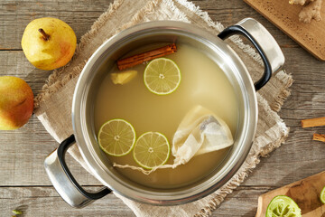 Pear juice with spices in a pot - preparation of a hot pear drink