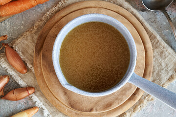 Bone broth or soup with fresh vegetables, top view