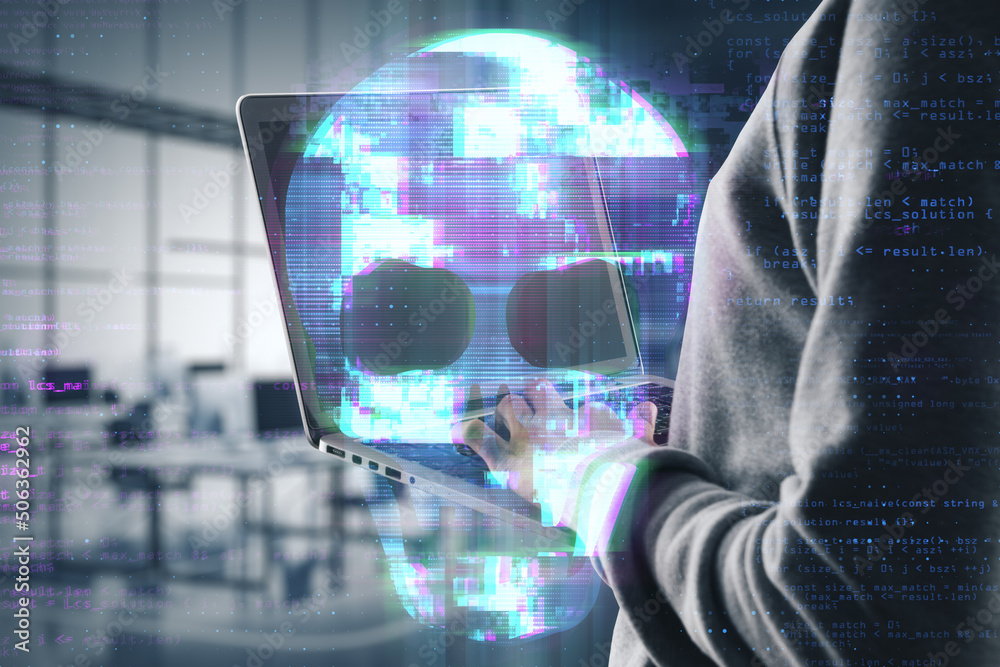 Poster close up of hacker hands using laptop with abstract digital skull hologram on blurry office interior