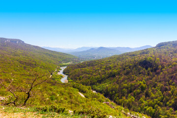 spring landscape with a view of forest hills and a river in the foothills of the Caucasus