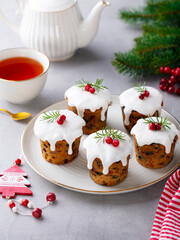 Christmas puddihgs, cakes with tea. Traditional dessert. Grey background.