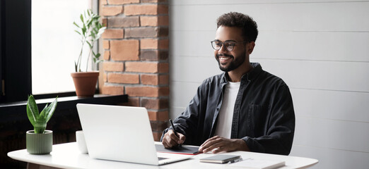 Young man student using laptop computer at home studying online panoramic banner. Creative professional working in office. Distance study, work from home, e-learning, business, meeting online