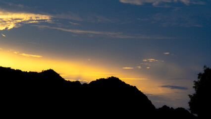 sky sunset light(gold) clouds, and mountain silhouette, copy space and abstract