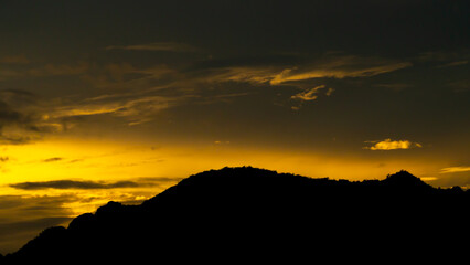 sky sunset light(gold) clouds, and mountain silhouette, copy space and abstract