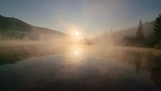 misty lake the morning of the reservoir With yellow sunlight, Ban Rak Thai, Mae Hong Son, Thailand