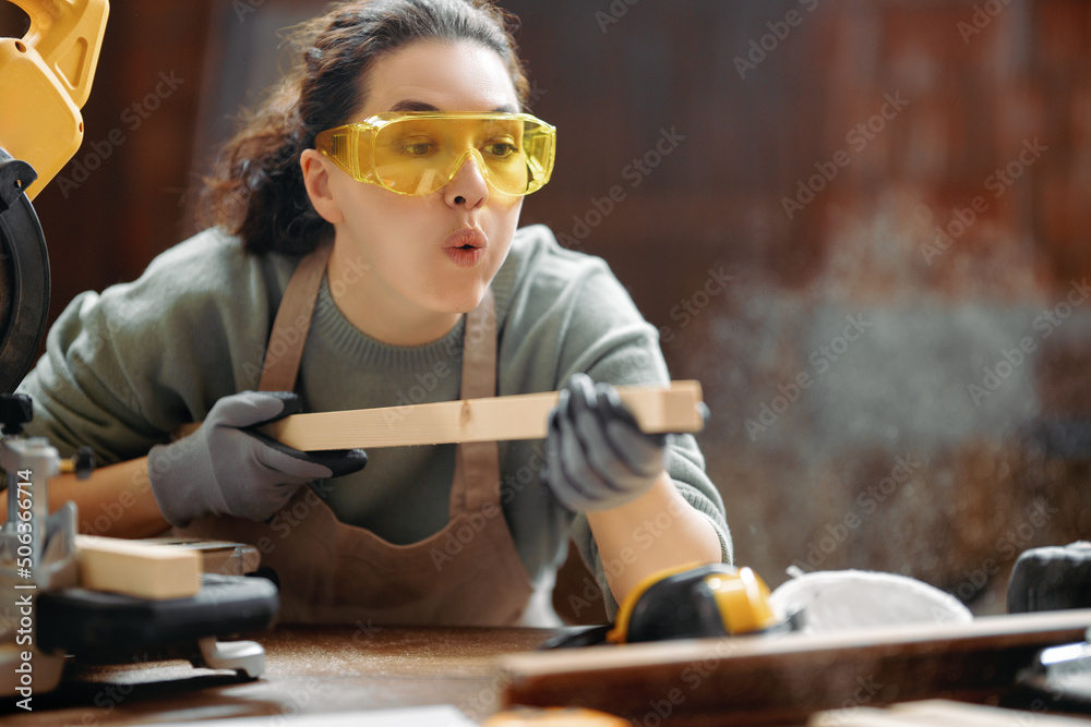 Wall mural woman carpenter in workshop