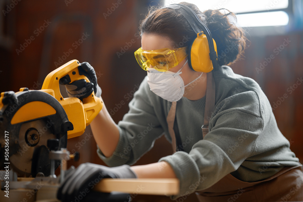 Wall mural woman carpenter in workshop