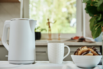 Tea time, Electric kettle with boiled water and cup for preparing tea on table, Morning breakfast...