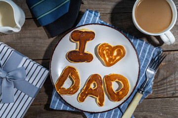 Father day pancakes. Homemade kids cooked father day pancakes with lettering I love dad, on plate,...
