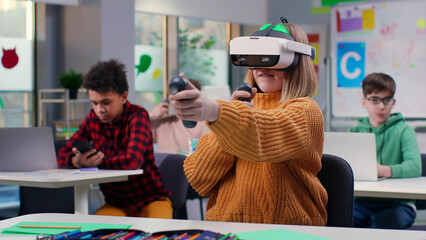 Teenage girl using vr headset in classroom