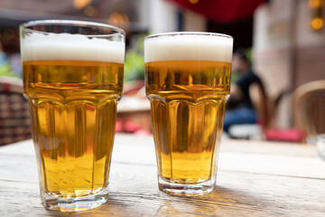 Two cups of beer over restaurant table