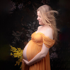 Young beautiful redhead woman pregnant and expecting a baby over flowers background with happy and...