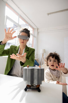 Mother and daughter exploring high-tech development the metaverse using virtual reality simulator