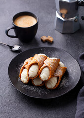 Cannoli Italian dessert on a plate with cup of coffee. Grey background. - 506371736