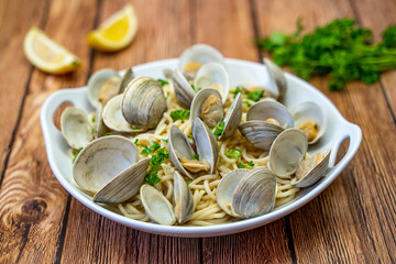 Little Neck Clams with pasta on a white plate. Pasta with clams. 