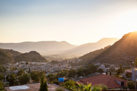 Town by mountains on sunny day, Delvina, Albania